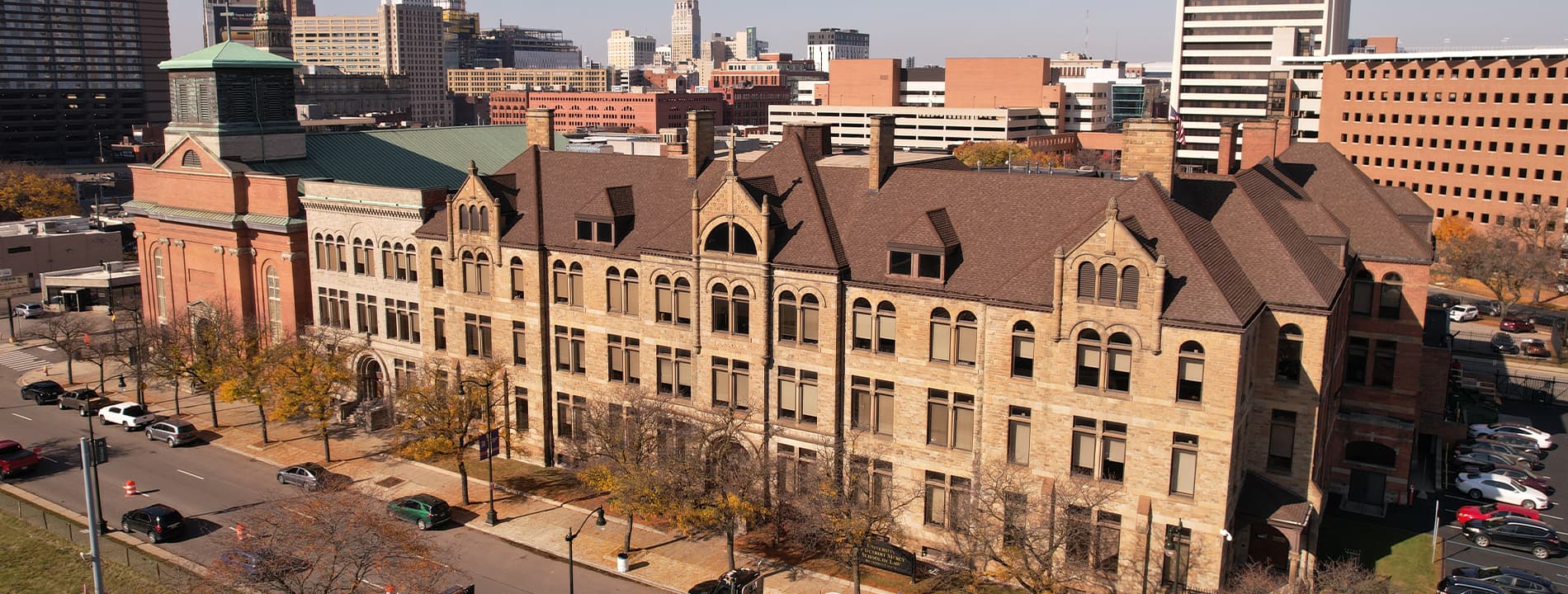 An aerial photo of the School of Law in downtown ɫۺϾþ with cars and other buildings pictured on a sunny day.